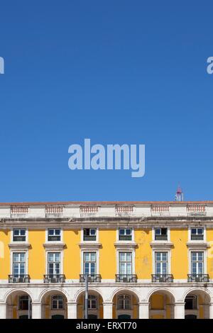 Colourful buildings in Praca de Comercio of Lisbon against a bright blue sky in summer Stock Photo