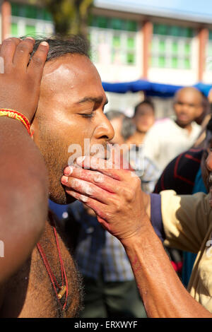 Face piercing, Preparation for the Tamil Hindu Thaipusam celebration in the Thai month when the star Pusam is at its height Stock Photo