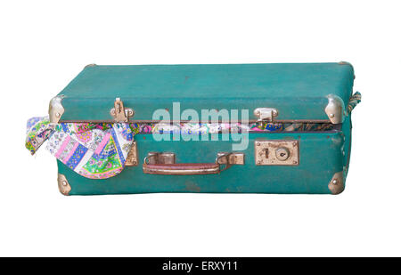 A very old suitcase open slightly with old clothes. Stock Photo
