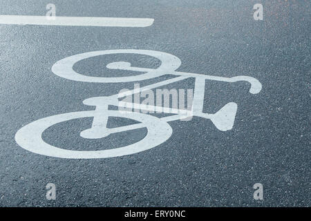 A Bicycle Road Sign on the Side on Wet Tarmac Stock Photo