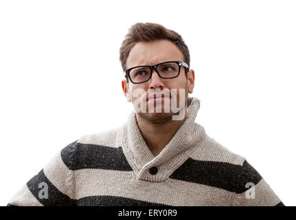 Portrait of a handsome young man with a perplexed expression, against a white background Stock Photo