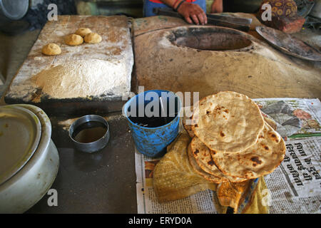 making roti in kitchen tandoor , Dhaba , roadside restaurant ,  Pratapgarh ; Uttar Pradesh ; India , asia Stock Photo