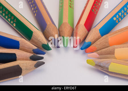 Set of crayons pointing to the center on white background Stock Photo