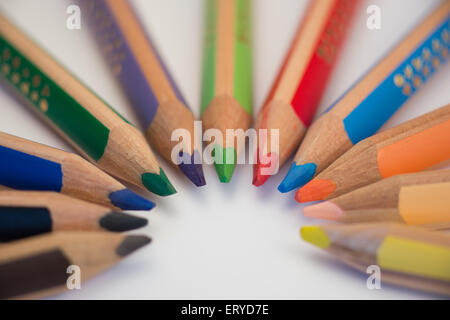 Set of crayons pointing to the center on white background Stock Photo