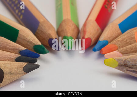 Set of crayons pointing to the center on white background Stock Photo