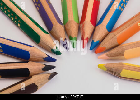 Set of crayons pointing to the center on white background Stock Photo