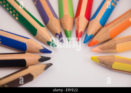 Set of crayons pointing to the center on white background Stock Photo