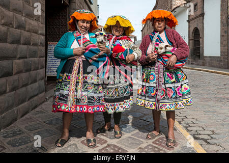 Traditionally dressed women with lambs, Cusco, Peru Stock Photo