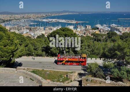 Tourist bus at Bellver Castle, Palma de Mallorca behind, Majorca, Balearic Islands, Spain Stock Photo