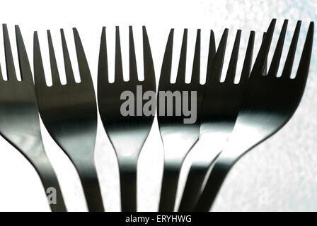 Forks , stainless steel kitchen utensil on white background Stock Photo