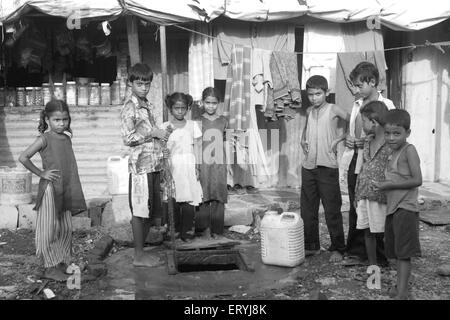 Children in slums collecting water in Malvani slum Malad Bombay Mumbai Maharashtra India Stock Photo