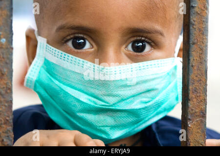 Boy wearing mask avoiding swine flu ; Bombay Mumbai ; Maharashtra ; India NO MR Stock Photo