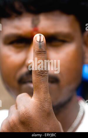 Voter showing finger with indelible ink mark after voting in election , Bombay ,  Mumbai , Maharashtra , India , Asia Stock Photo