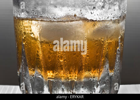 Drinks ; shimmering glass of whisky with ice Stock Photo