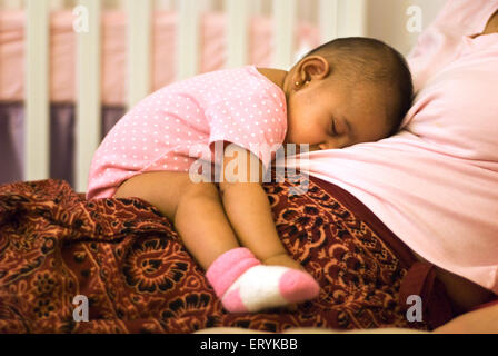 Baby sleeping on mothers lap , MR#447G Stock Photo