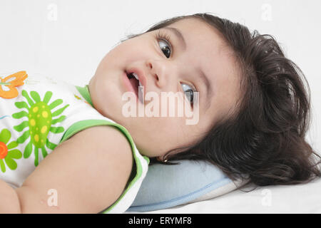 Fifteen month old baby girl lying down MR#743S Stock Photo