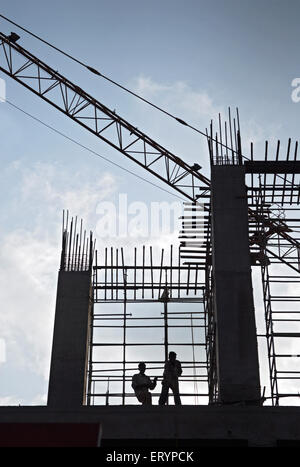 Workers on construction site in Bombay Mumbai  ; Maharashtra  ; India 5 May 2009 Stock Photo