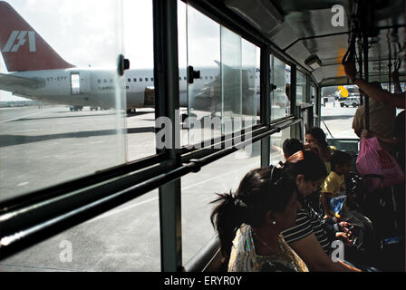 Passengers in shuttle bus from airport terminal to aircraft , Chhatrapati shivaji domestic airport ; Bombay , Mumbai ; Maharashtra ; India , Asia Stock Photo