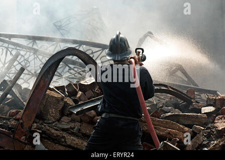 Firemen dousing blaze , Behrampada slums fire , Bandra , Bombay ,  Mumbai , Maharashtra , India , Asia , Indian , Asian Stock Photo