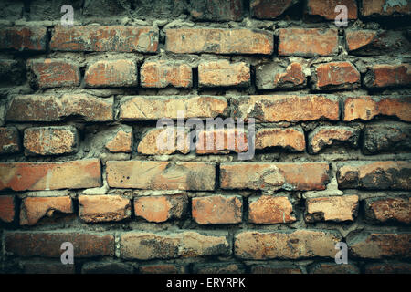 Background of colorful brick wall texture. brickwork. Peeling paint. Pattern of rustic grunge material. Stock Photo