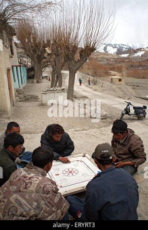 Men playing carom in Mulbekh village ; Leh ; Ladakh ; Jammu and Kashmir ; India NO MR 10 April 2008 Stock Photo