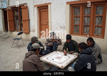 Men playing carom in Mulbekh village ; Leh ; Ladakh ; Jammu and Kashmir ; India NO MR 10 April 2008 Stock Photo