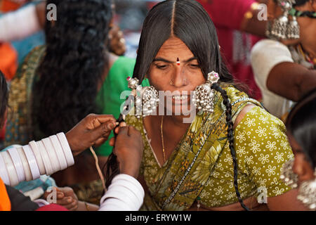 Gypsy tribal nomad tribe woman wearing bangles silver jewelry , Nanded , Marathwada , Maharashtra , India , Asia Stock Photo