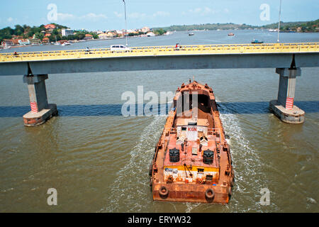 Iron ore transported through shipping on Mandovi river Panji  ; Goa  ;  India NOMR Stock Photo