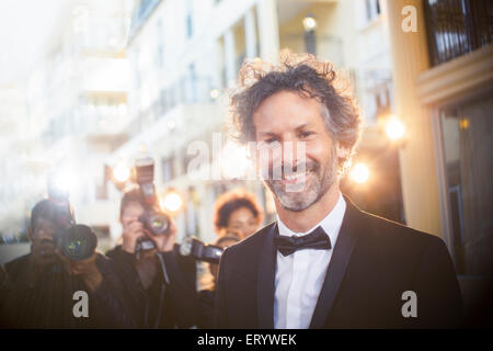 Portrait of celebrity at event with paparazzi in background Stock Photo