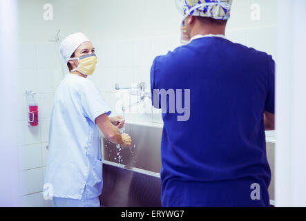 Surgeons washing hands in hospital Stock Photo