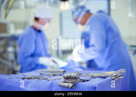 Surgical scissors on tray in operating room Stock Photo