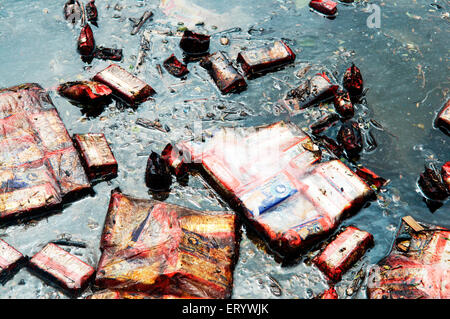 Oil soaked biscuit packets floating due to container ship chitra colliding in sea Bombay Mumbai ; Maharashtra ; India Stock Photo