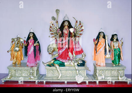 Goddess durga killing demon mahishasura with goddesses laxmi saraswati and gods ganesh kartik at kolkata ; Calcutta ; India Stock Photo