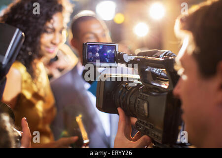 Close up of paparazzi filming celebrity couple at event Stock Photo
