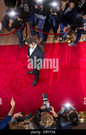 Celebrity being photographed by paparazzi photographers at red carpet event Stock Photo