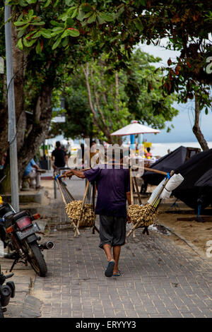 A food seller walks on the streets and sells peanuts Stock Photo