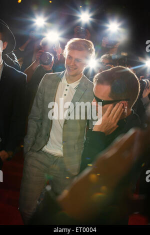 Celebrity on red carpet being interviewed and photographed by paparazzi ...