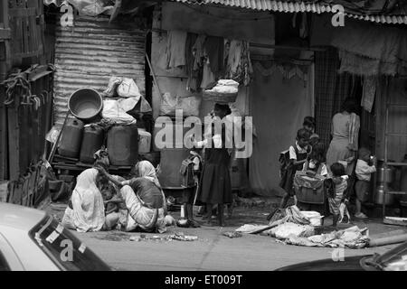 Naked children two boys and one girl bathing Byculla slums 