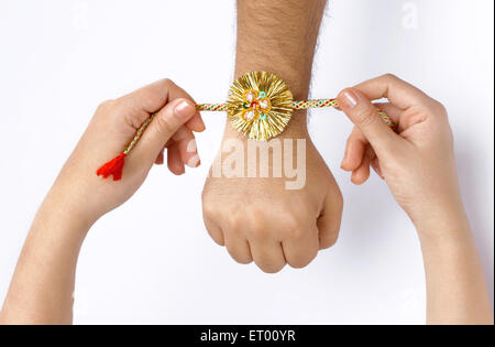 Raksha Bandhan festival ; sister tying rakhi on brother's hand ; Bombay now Mumbai ; Maharashtra ; India Stock Photo