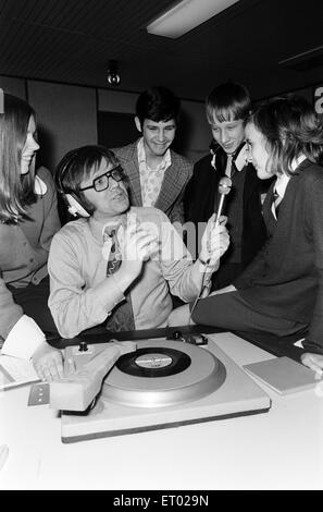 Ed Doolan BRMB Radio Disc Jockey, pictured with news boys and girls, Birmingham, 14th January 1975. Stock Photo