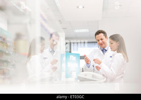 Pharmacists reviewing prescription in pharmacy Stock Photo