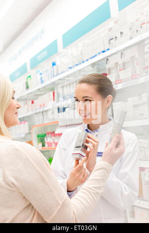 Pharmacist recommending product to customer in pharmacy Stock Photo
