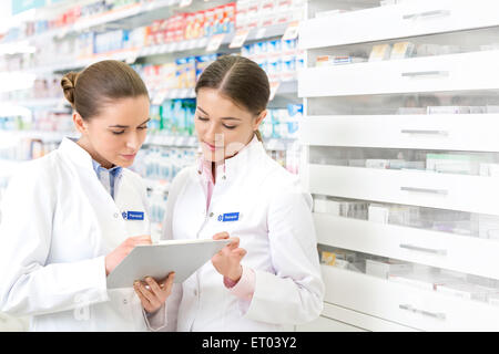 Pharmacists with clipboard in pharmacy Stock Photo