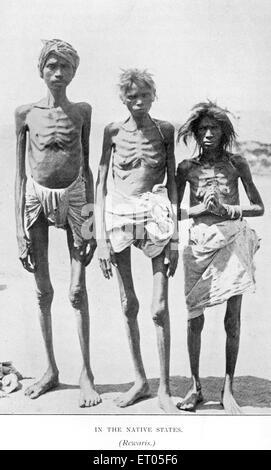 three hungry men in India with ribs showing due to famine 1900s Stock Photo