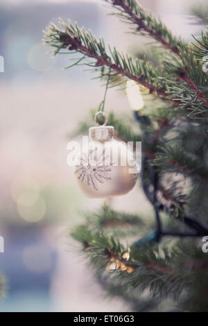 Silver ornament hanging on Christmas tree Stock Photo