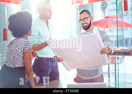 Architects discussing blueprints Stock Photo