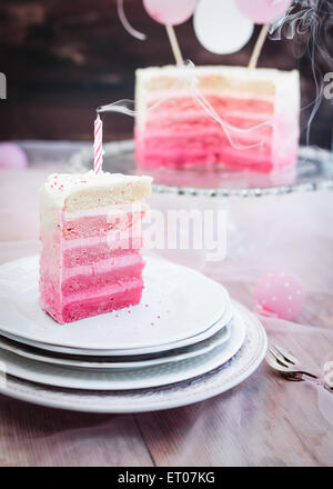 Pink and white piece of birthday cake. Selective focus.