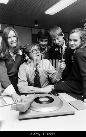 Ed Doolan BRMB Radio Disc Jockey, pictured with news boys and girls, Birmingham, 14th January 1975. Stock Photo