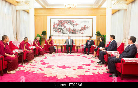 Beijing, China. 10th June, 2015. Chinese President Xi Jinping (C) meets with the 11th Panchen Lama Bainqen Erdini Qoigyijabu (L, rear) in Beijing, capital of China, June 10, 2015. Credit:  Lan Hongguang/Xinhua/Alamy Live News Stock Photo