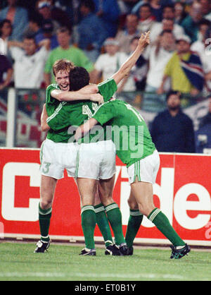 World Cup Group F match at the Stadio Sant'Elia in Cagliari, Italy. England 1 v Republic of Ireland 1. Kevin Sheedy is congratulated by teammates Steve Staunton and ndy Townsend after scoring the equalising goal. 11th June 1990. Stock Photo